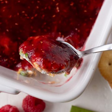 Close-up of raspberry dip with a spoonful of dip and fresh raspberries.